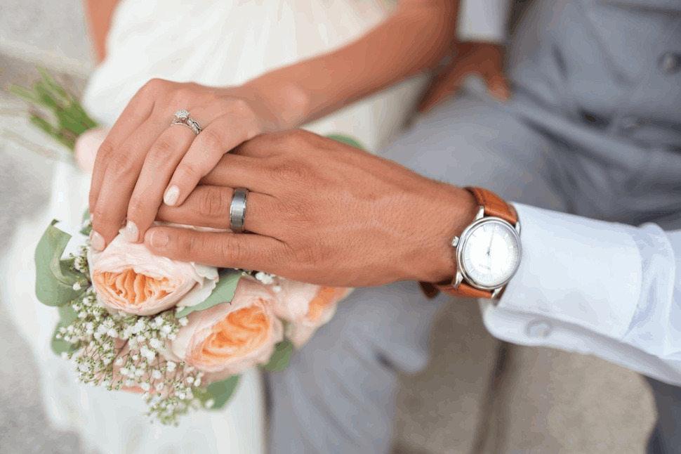 man and woman holding hands on a wedding ceremony