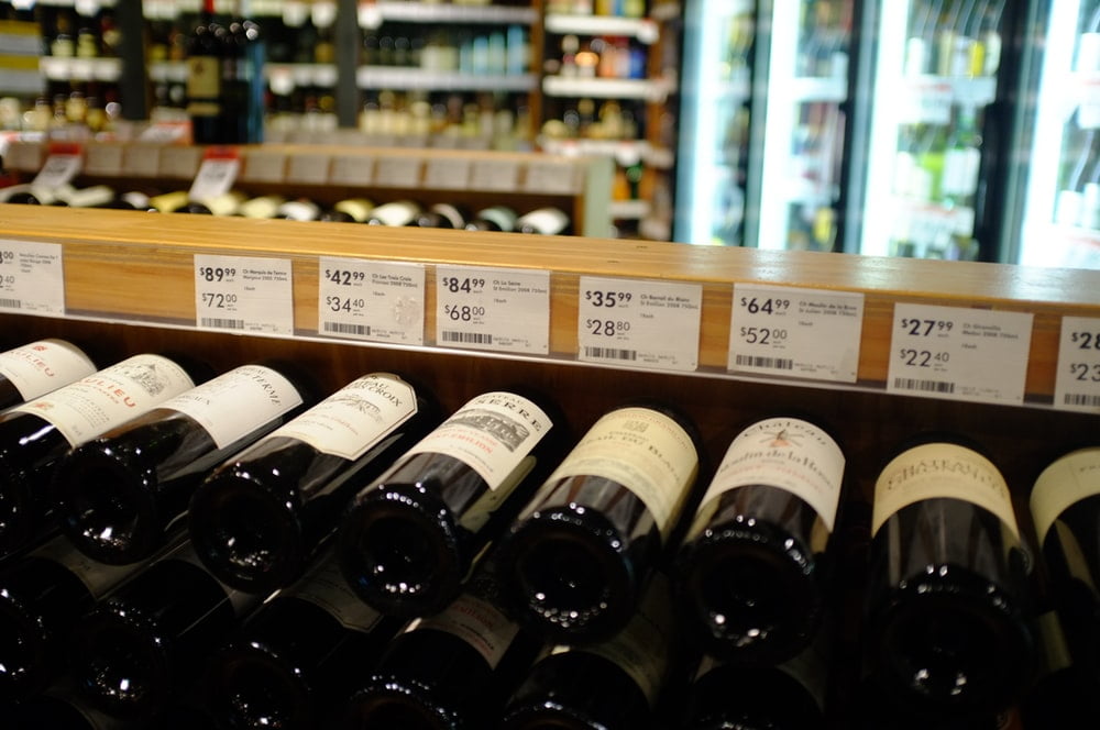 Wine bottles on display with each price tag clearly visible.