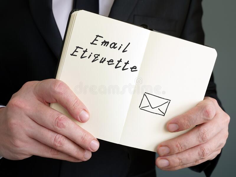 man wearing black suit holding email etiquette inscription page 