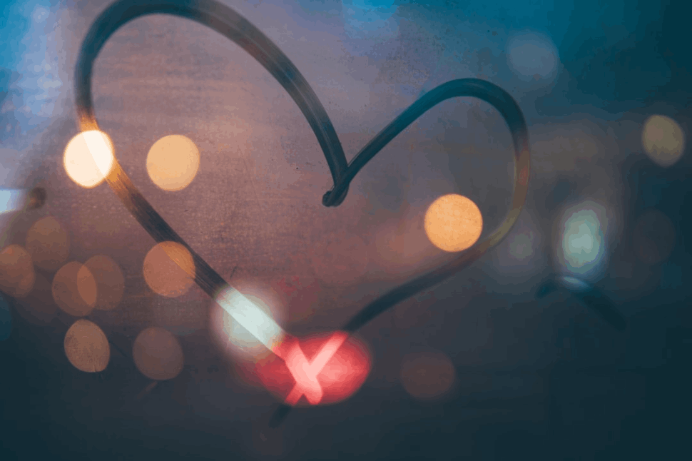 A heart marker print on a glass wall with a black background