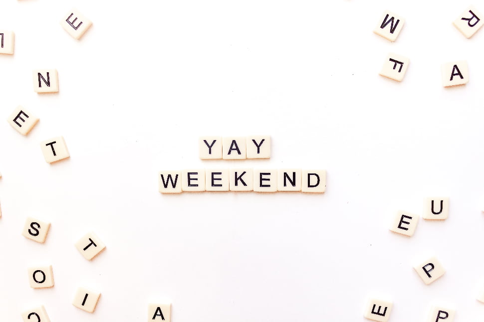 YAY WEEKEND text on scrabble blocks placed over a white background