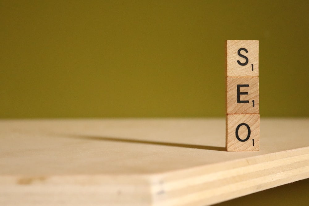 Stacked Scrabble tiles that read 
