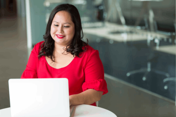 a selective focus photography of woman using laptop computer