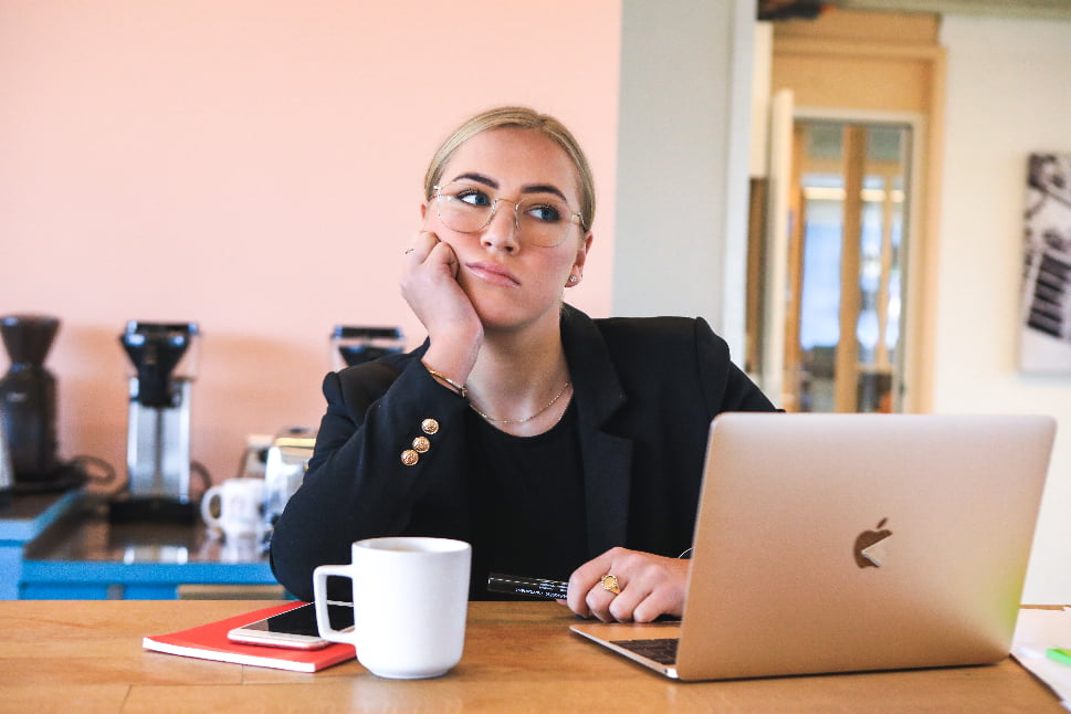 A woman with her hand on her face, thinking about something.