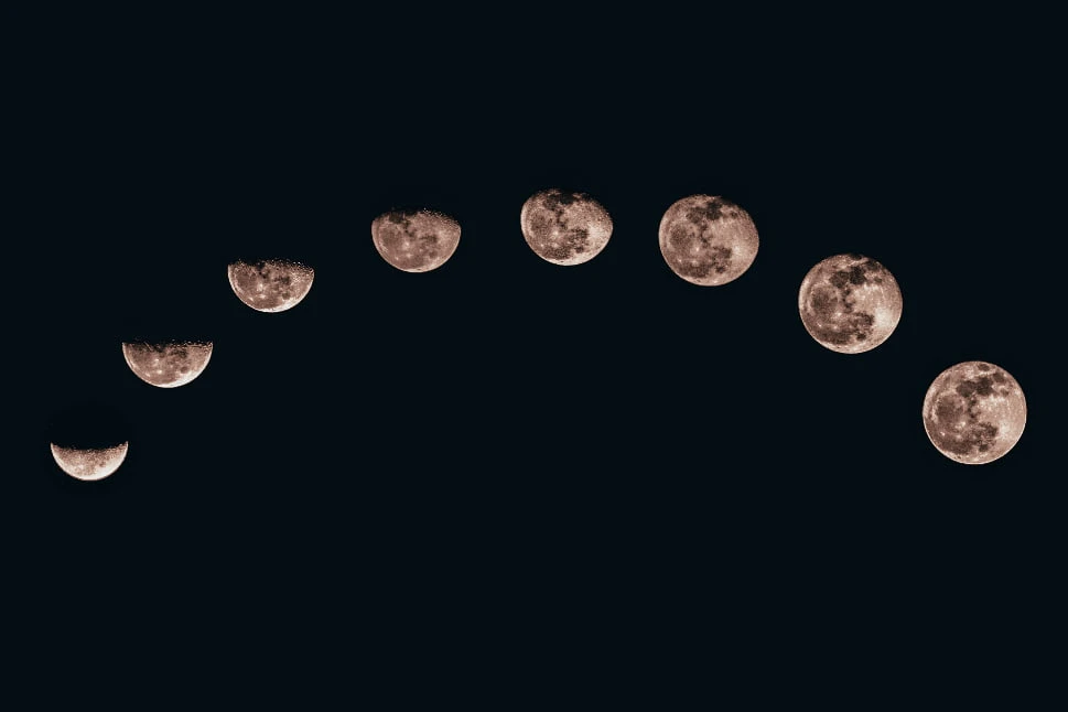 A photo of all the moon cycles in the night sky.