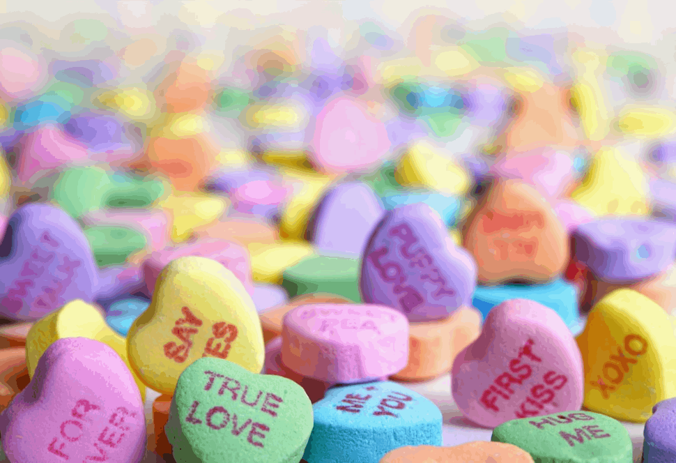 assorted candies that have text imprinted on them about love.