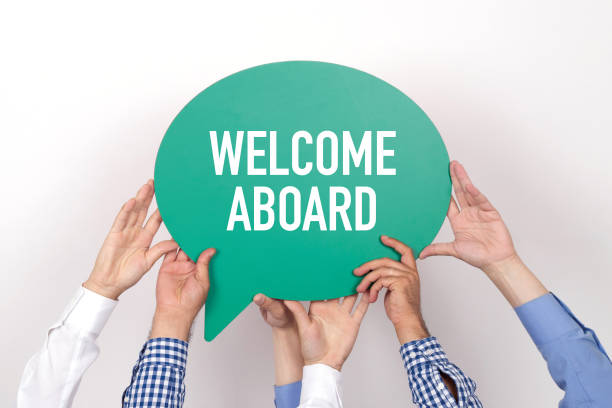 group of people holding the welcome aboard written speech bubble picture 