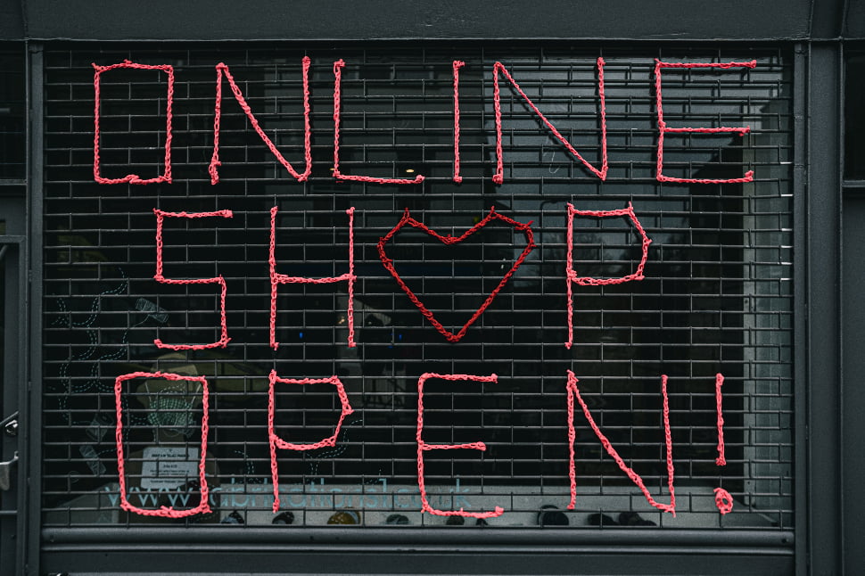 A shop sign with red text that says 