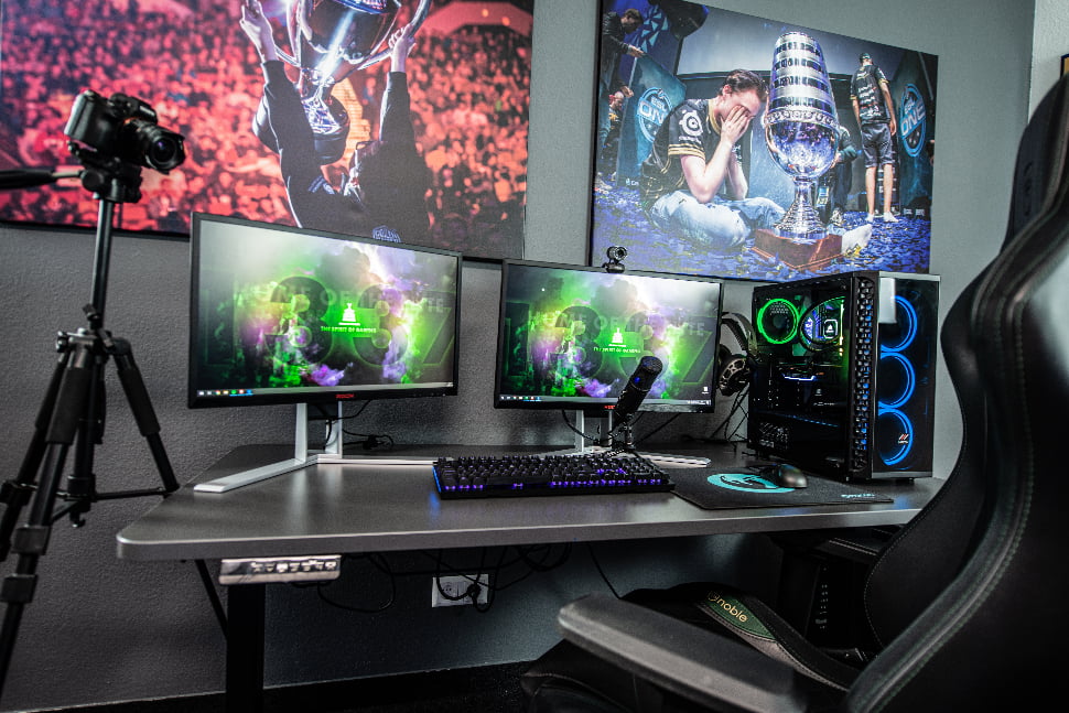 A gaming station with two monitors and recording equipment.