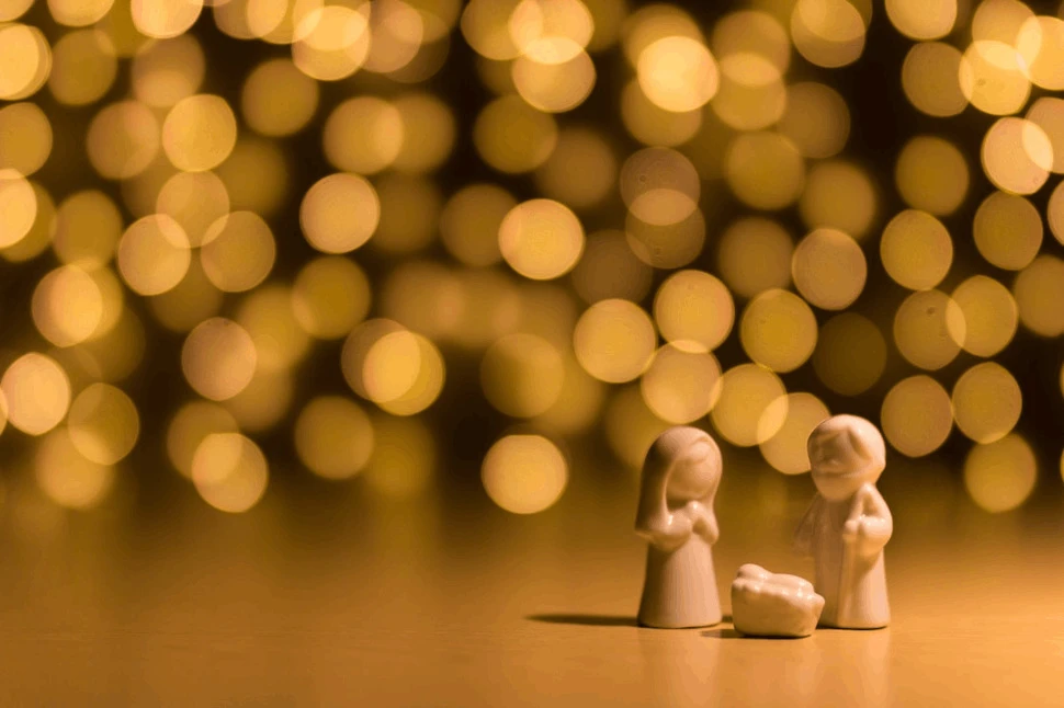 shallow focus photo of the Nativity figurine with star-looking lights behind