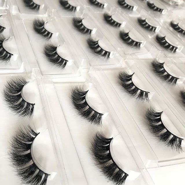 different lashes arranged on white and transparent background surface
