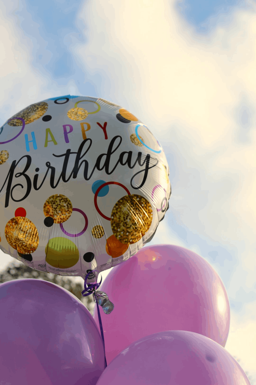 happy birthday balloons with happy birthday text and sky 