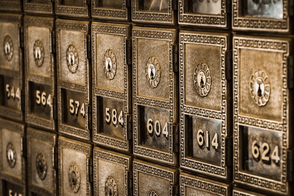 Numbers increasing by ten on metal deposit boxes in a bank.