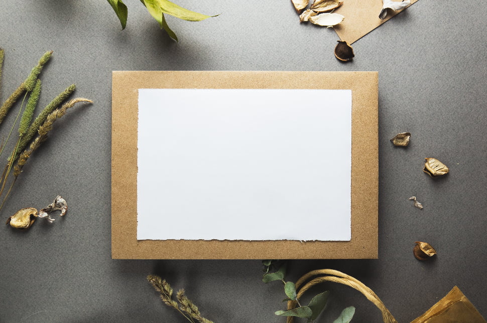 A blank white paper placed on top of a brown envelope.