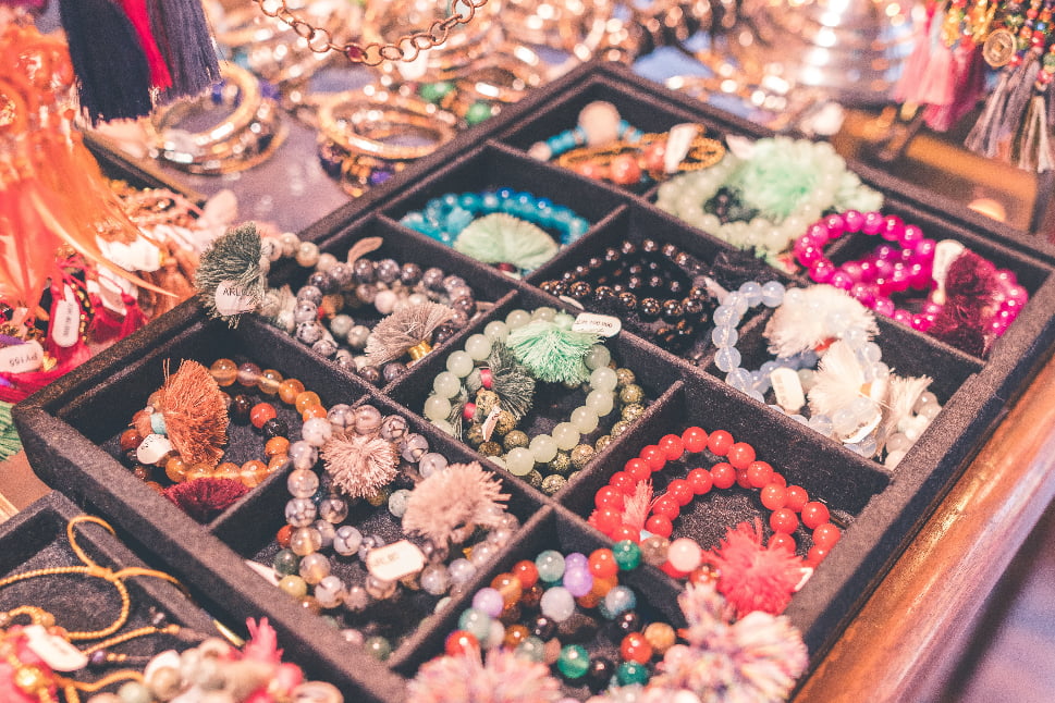 A display of beaded bracelets, necklaces, and other pieces of jewelry.