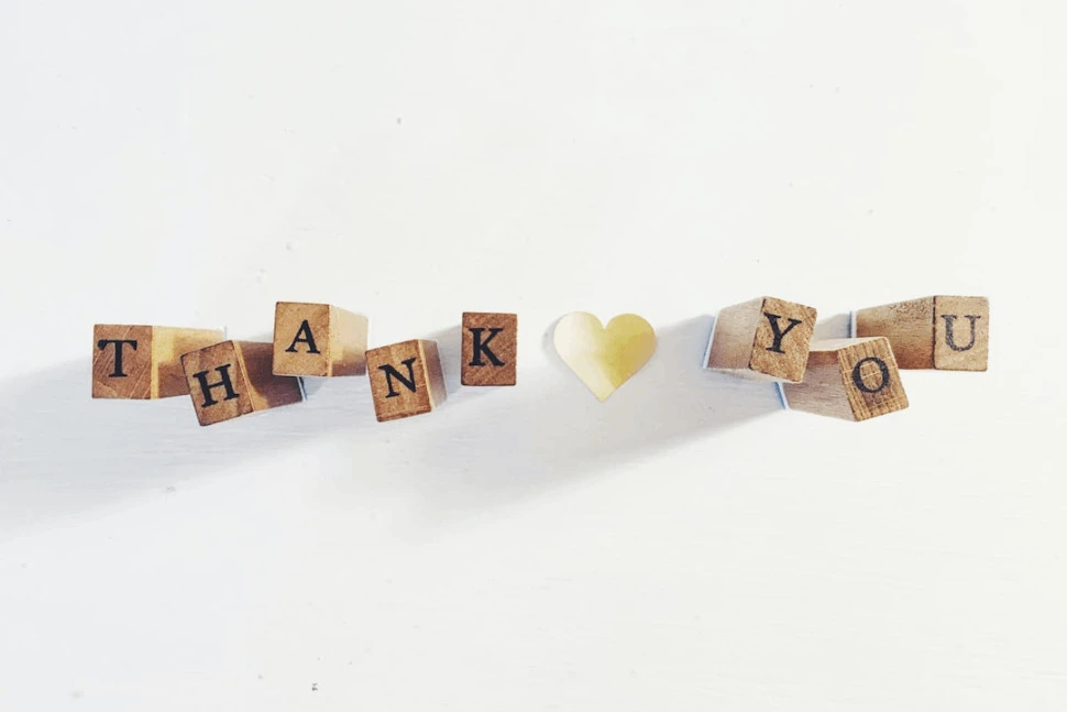A Thank You text on brown wooden blocks over a white background