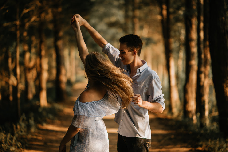 Beautiful shot of a couple holding hands and dancing. 