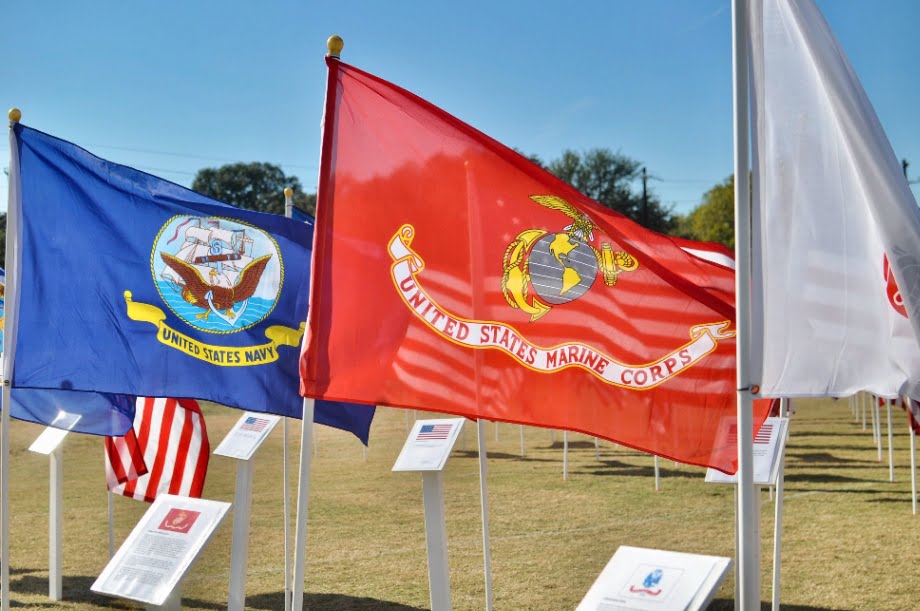 Picture of a US Navy and Marine Corp flags fluttering in the wind.