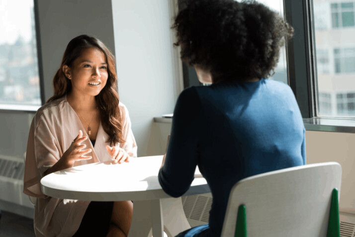 two women sitting on chair. Social worker and employer