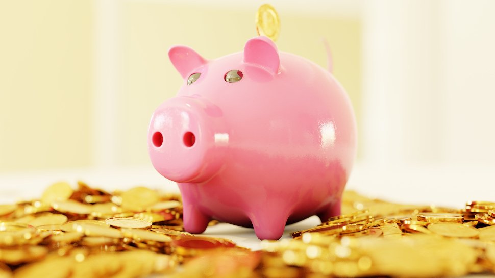 A pink piggy bank surrounded by a ton of golden coins.