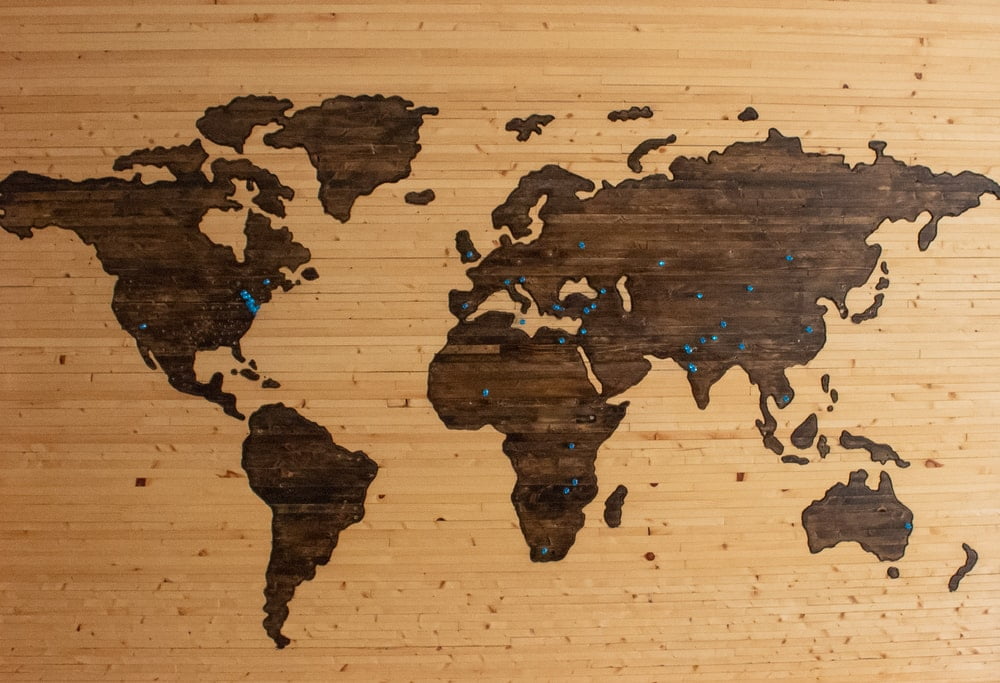 A brown wooden map board showing all countries in the world.