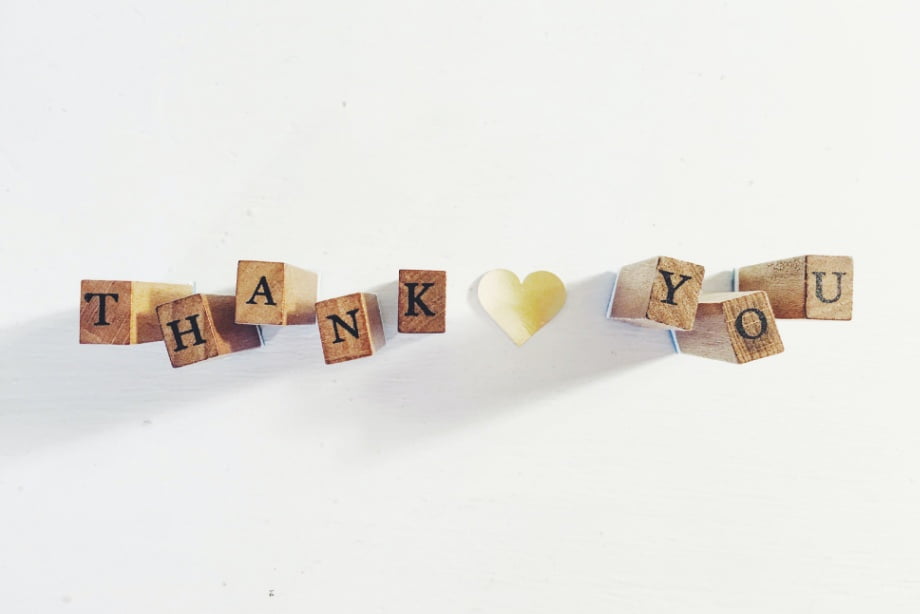 The words Thank You spelled using wooden letter blocks.