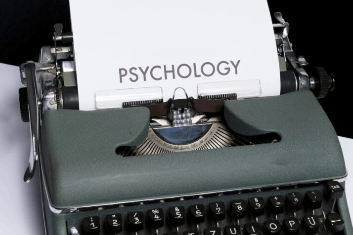 a white paper with the word Psychology on it placed in a  typewriter