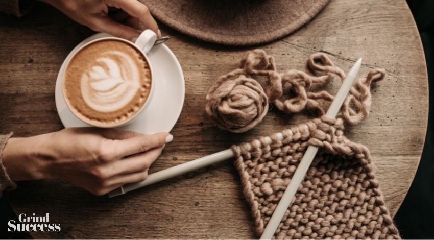 cup of brown coffee and crochet on brown table 