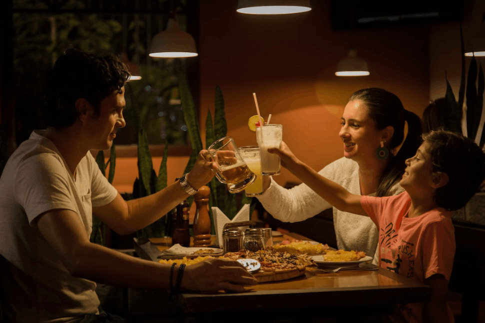 three members of a family having a toast on table