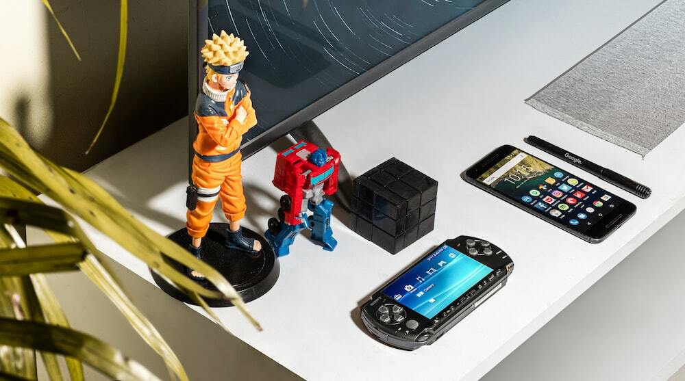 Picture of a Naruto and Optimus Prime action figures on a table.