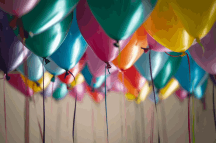 selective focus photography of different assorted-color birthday balloons hanging up