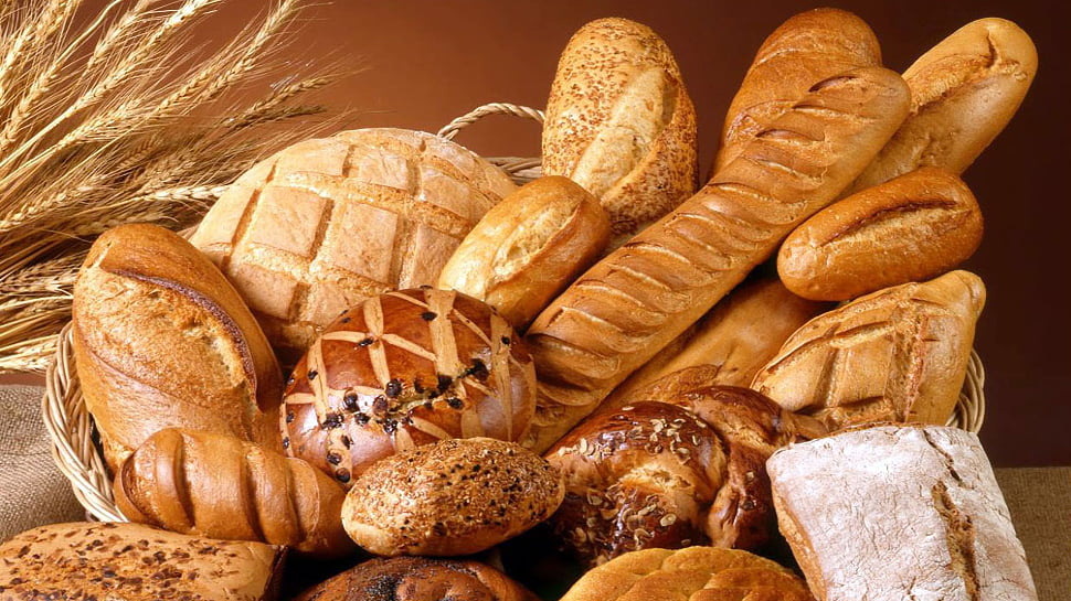 An assortment of breads, all in a large basket.