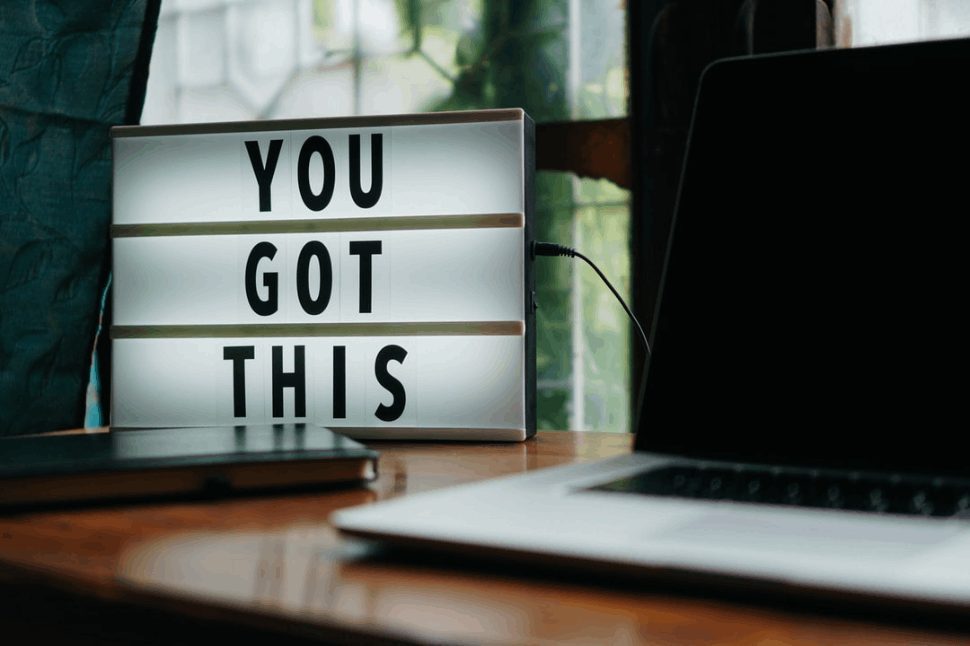 Inspirational message near a laptop, affirming that "You got this" and can succeed