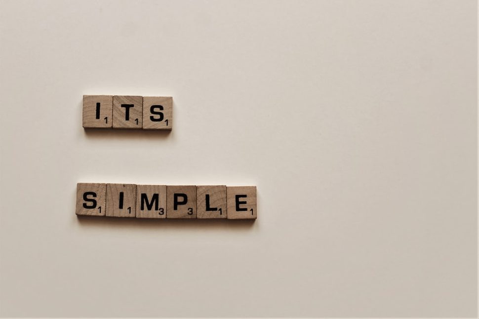 Quirky arrangement of Scrabble letters forming the phrase "It's simple" as a playful quote.