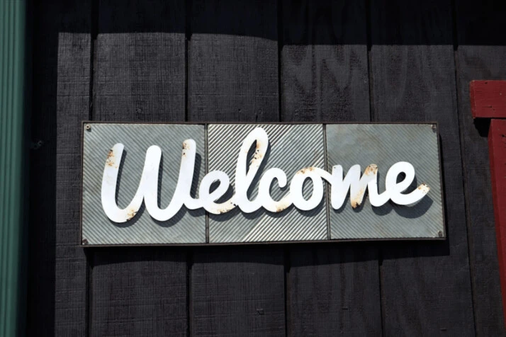 A white Welcome text LED light over a black background