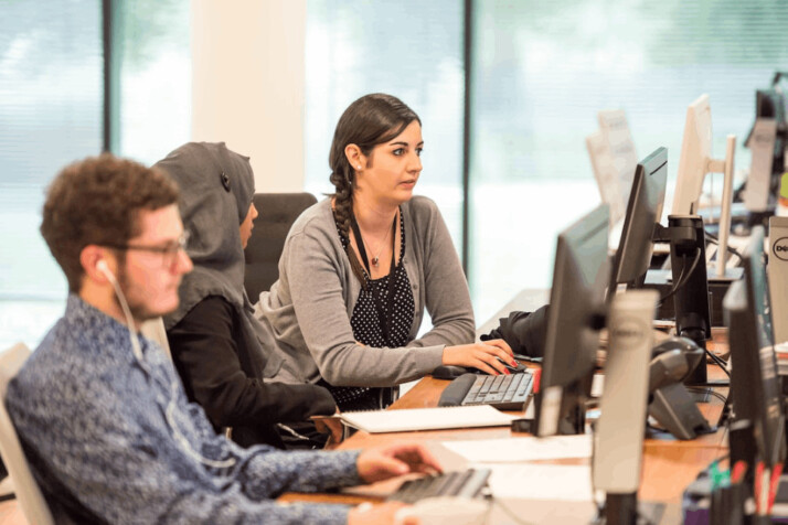 unknown persons using computer indoors