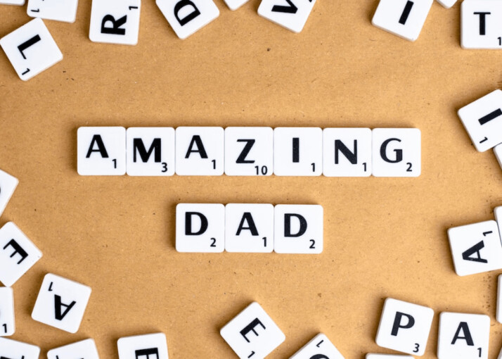 a white and black letter blocks with the text Amazing Dad on a brown surface