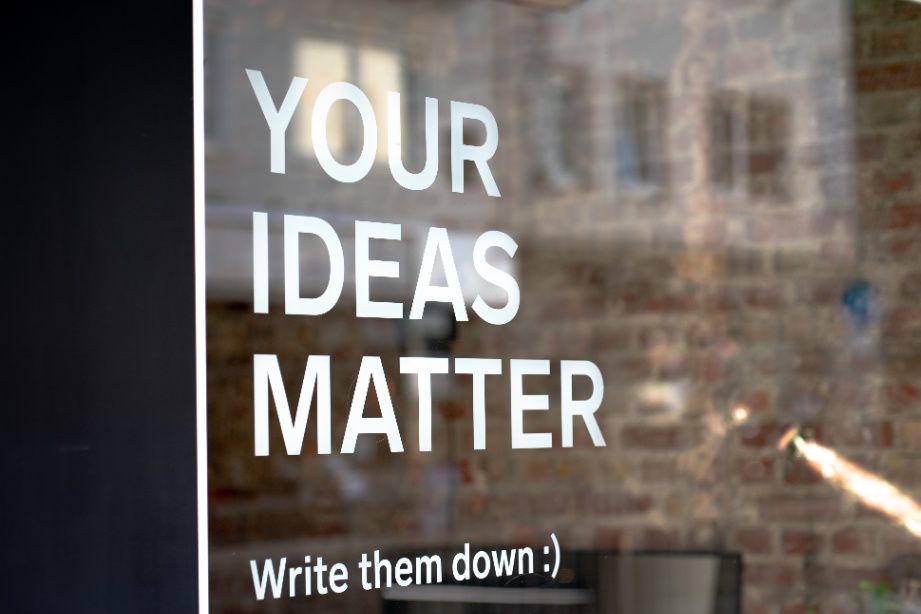 Your Ideas Matter text in white written over a glass door