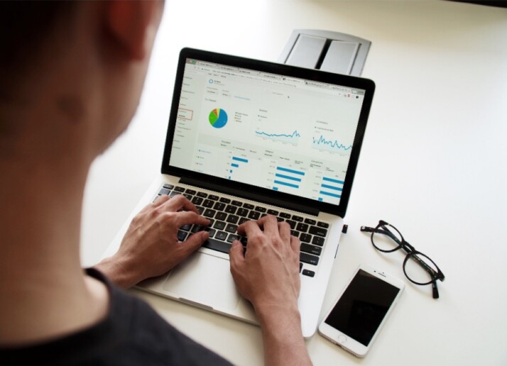 A guy working on a set of data displayed on his laptop.