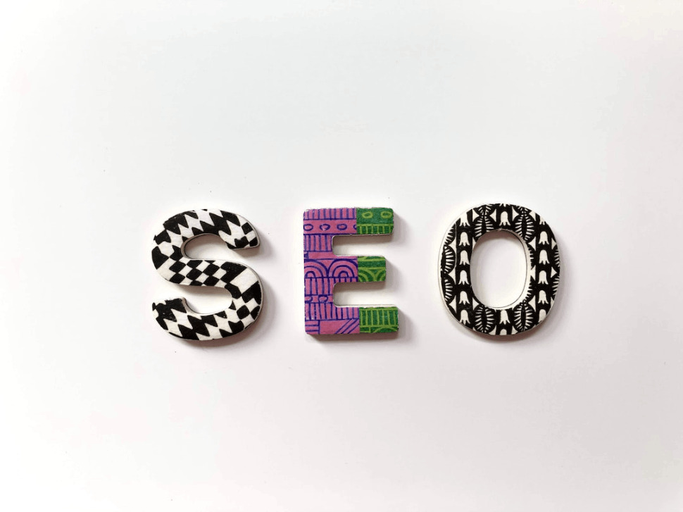 SEO text wallpaper with multicolored and grayscale pattern on the letters 