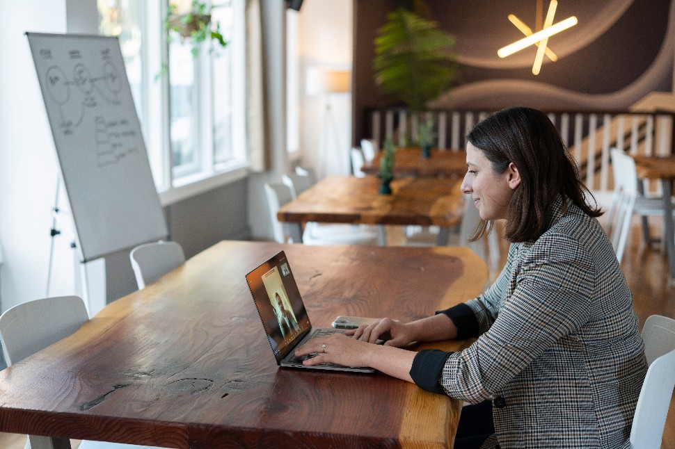 A woman talking to someone over video chat on her laptop.
