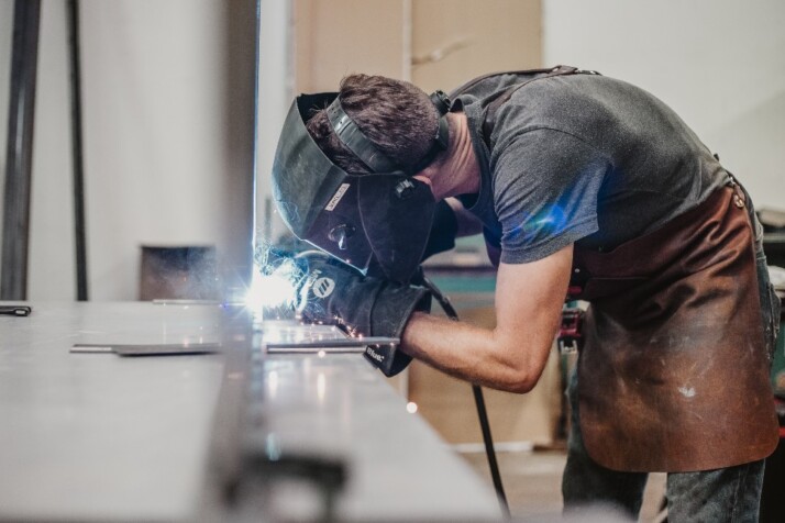 A man welding a sheet metal at the station