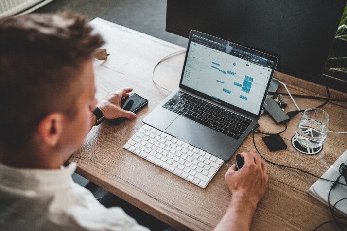 A man setting appointments on Google Calendar using his laptop.