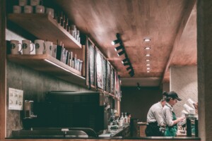 Starbucks employees working and receiving customer orders at the counter.